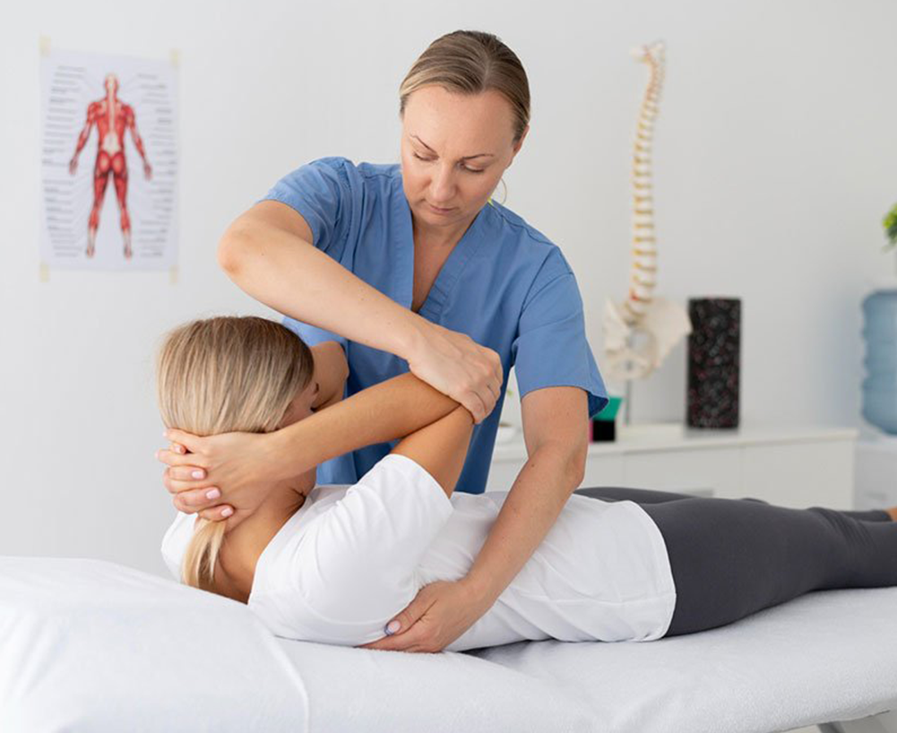Physiotherapist assisting a patient with shoulder treatment in a modern clinic setting, emphasizing healthcare services offered by Allevia Centers.
